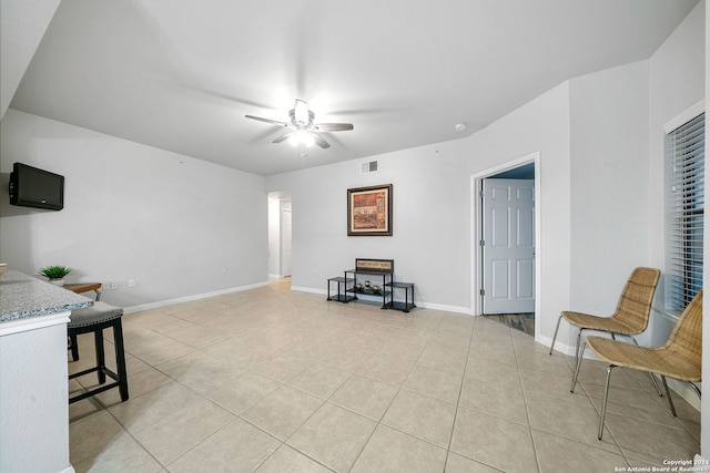 tiled living room featuring ceiling fan