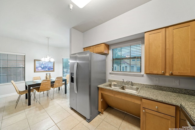 kitchen featuring a notable chandelier, sink, stainless steel fridge, and light tile floors