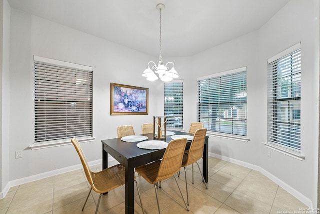 tiled dining room with a notable chandelier