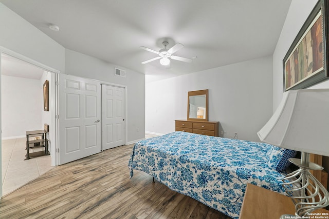 bedroom with a closet, ceiling fan, and tile floors