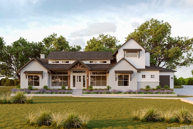 view of front facade with a front yard and a garage