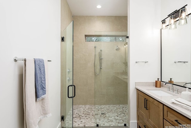 bathroom featuring vanity and an enclosed shower