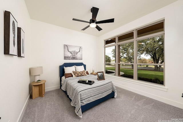 bedroom featuring ceiling fan and carpet