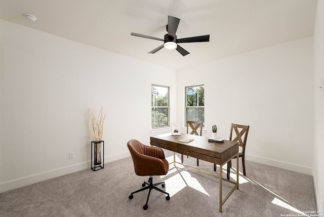 carpeted home office with ceiling fan