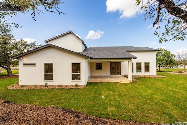 rear view of property with a yard and a patio