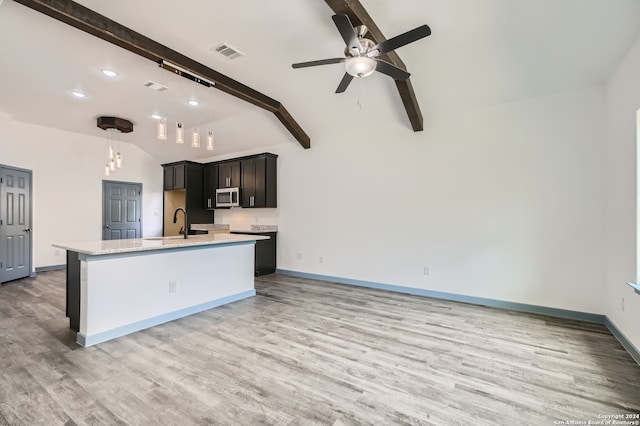 kitchen featuring hanging light fixtures, hardwood / wood-style flooring, lofted ceiling with beams, and ceiling fan with notable chandelier