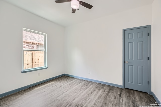 unfurnished room with wood-type flooring and ceiling fan