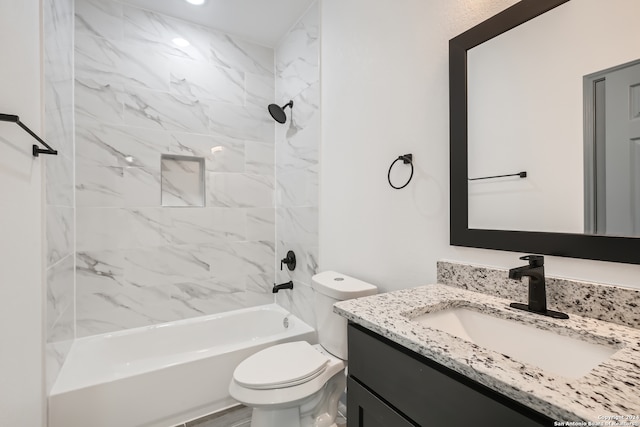 full bathroom featuring tiled shower / bath combo, toilet, and vanity