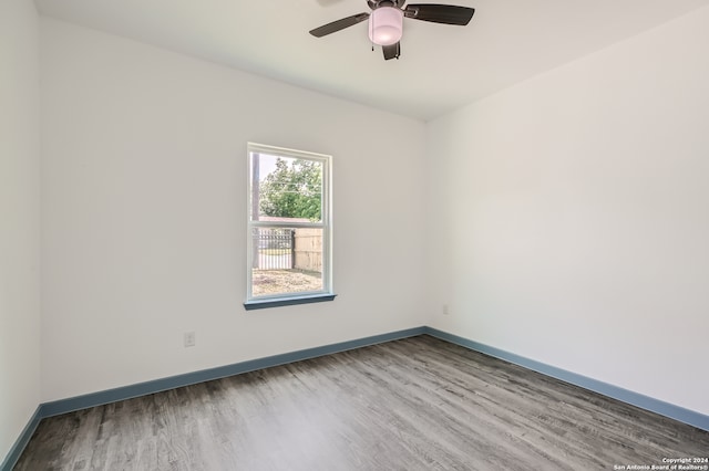 empty room with ceiling fan and hardwood / wood-style flooring