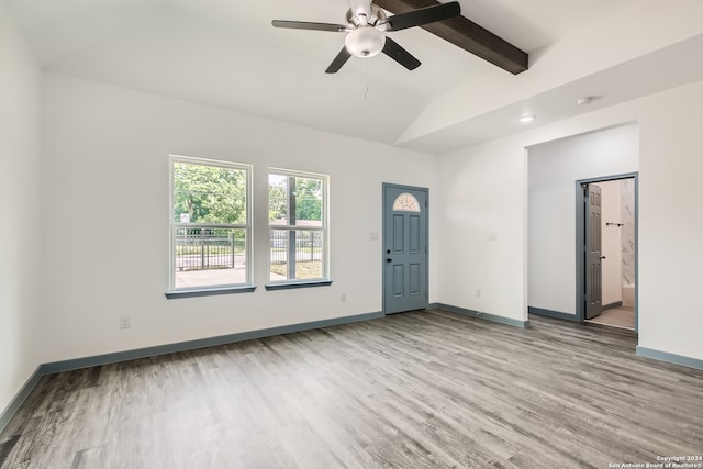 interior space with ceiling fan, vaulted ceiling with beams, and wood-type flooring