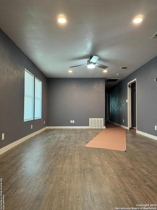 spare room with dark hardwood / wood-style floors and ceiling fan