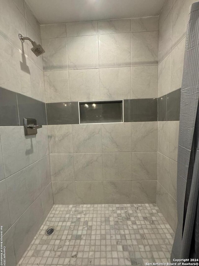 bathroom with a tile shower