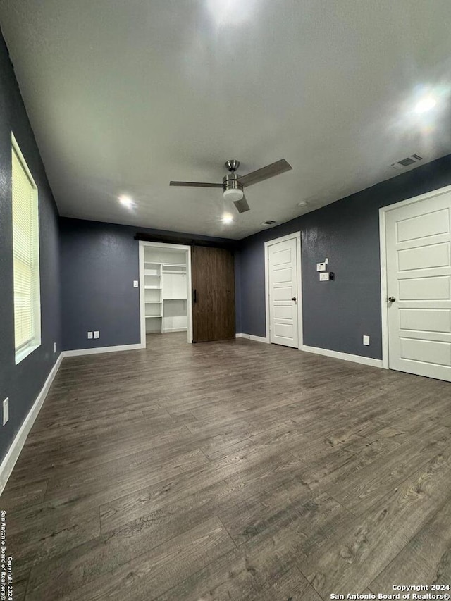 interior space featuring ceiling fan and dark hardwood / wood-style flooring