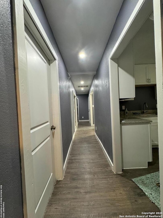 corridor featuring sink and dark hardwood / wood-style flooring