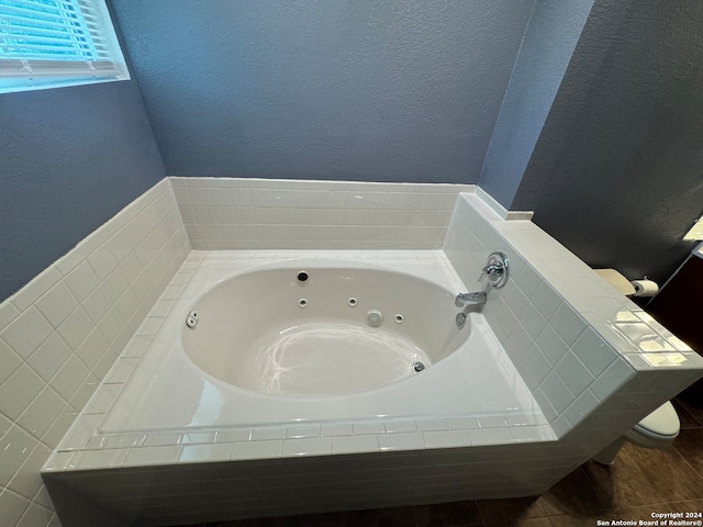 bathroom featuring a relaxing tiled bath