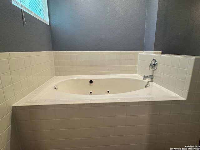 bathroom featuring tiled bath