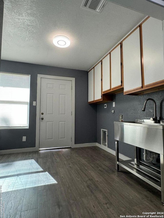 kitchen featuring white cabinets, dark hardwood / wood-style floors, and a textured ceiling