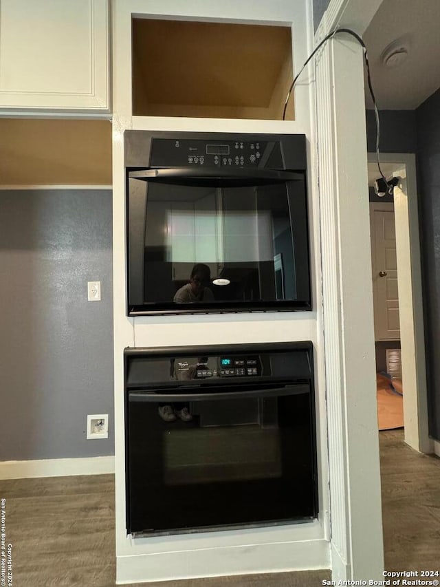 room details with oven and dark hardwood / wood-style floors