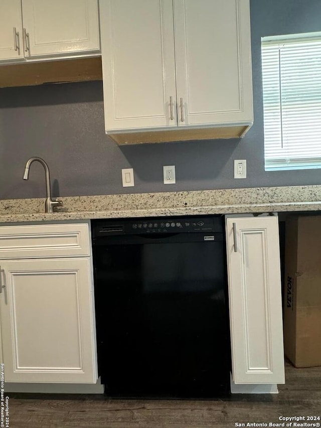 kitchen featuring sink, dark hardwood / wood-style floors, dishwasher, and light stone countertops