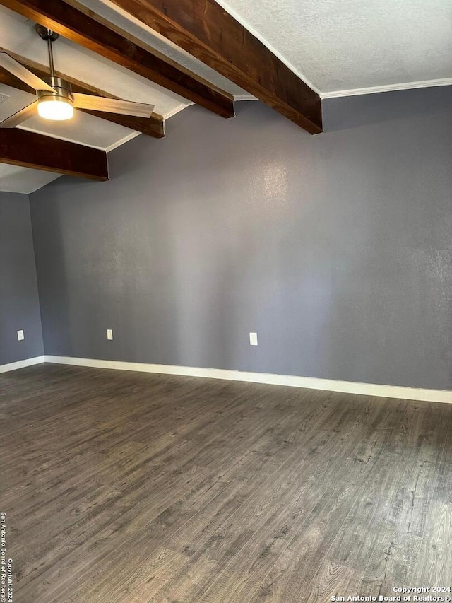 spare room featuring ceiling fan, dark hardwood / wood-style flooring, a textured ceiling, and lofted ceiling with beams