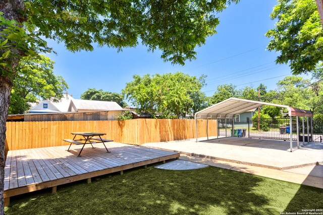 wooden terrace with a lawn