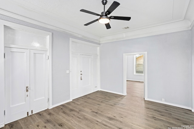 empty room featuring crown molding, ceiling fan, and hardwood / wood-style flooring