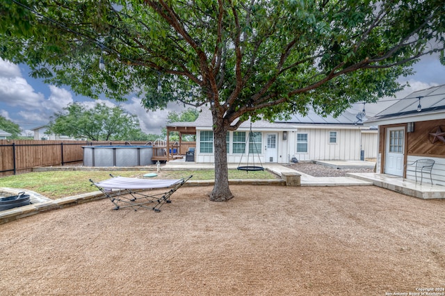 rear view of property with a patio and a fenced in pool