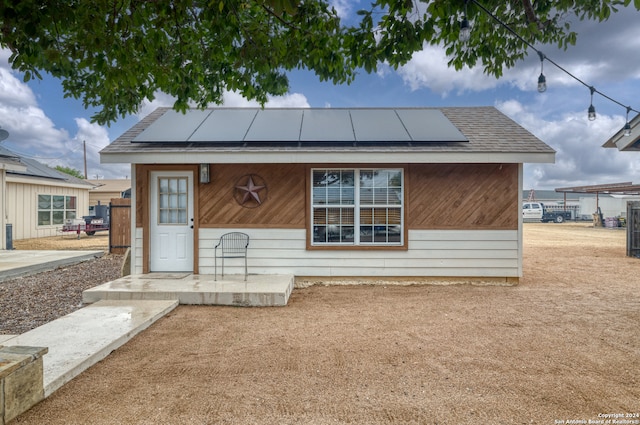 bungalow-style home with solar panels