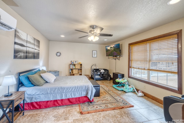 tiled bedroom with an AC wall unit, ceiling fan, and a textured ceiling