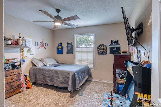 carpeted bedroom with ceiling fan and a textured ceiling