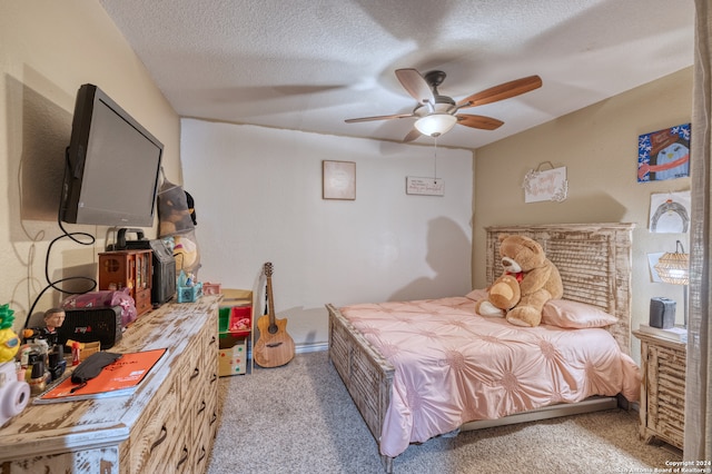 bedroom with ceiling fan, a textured ceiling, and light carpet