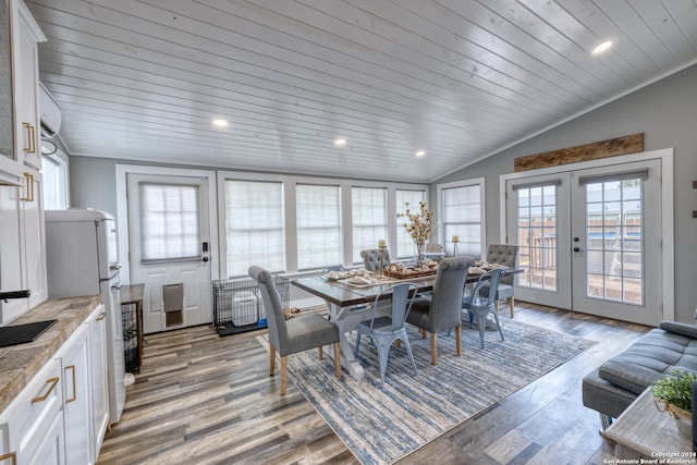 dining area featuring a wealth of natural light, french doors, hardwood / wood-style flooring, and vaulted ceiling