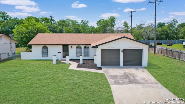 ranch-style home featuring a garage and a front lawn