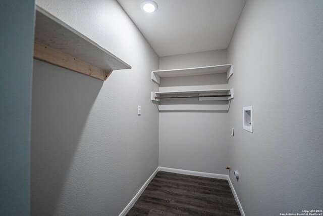 washroom featuring dark wood-type flooring, hookup for a washing machine, and hookup for a gas dryer