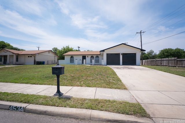 ranch-style house featuring a front yard and a garage