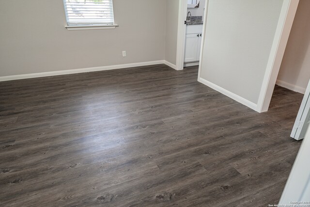 spare room featuring dark wood-type flooring