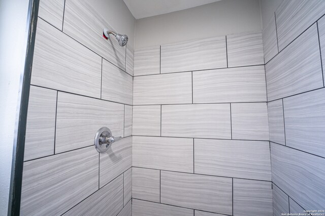 bathroom with a tile shower