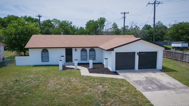 ranch-style home with a garage and a front lawn