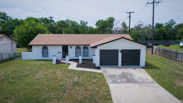 ranch-style house with a garage and a front lawn