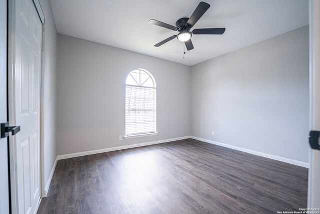 spare room with ceiling fan and dark hardwood / wood-style floors