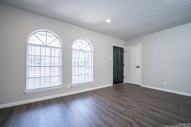 spare room with dark hardwood / wood-style floors