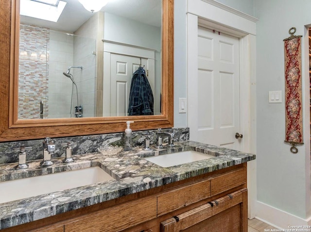 bathroom featuring tiled shower, vanity, a skylight, and backsplash