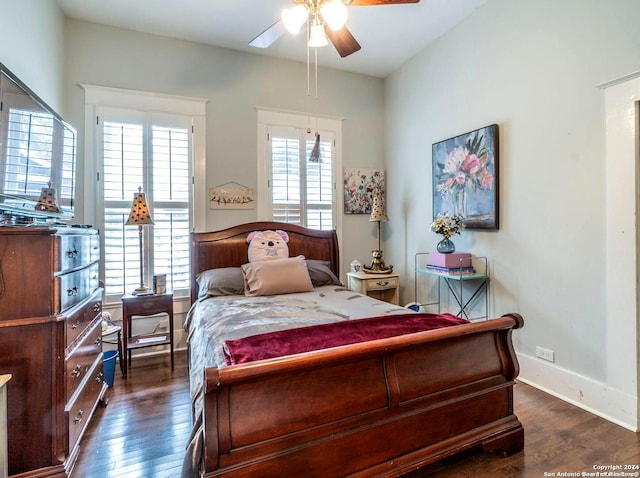 bedroom featuring multiple windows, ceiling fan, and dark wood-type flooring