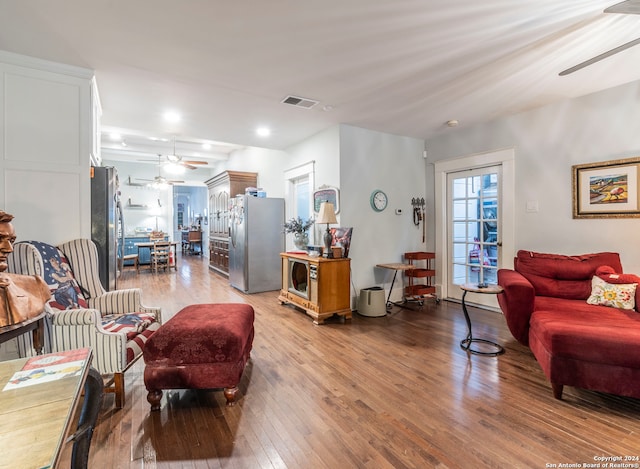 living room with light wood-type flooring and ceiling fan