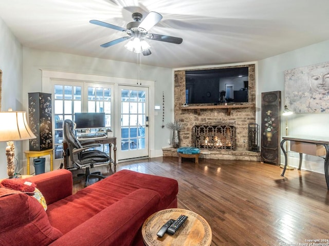 living room with a fireplace, ceiling fan, and hardwood / wood-style floors