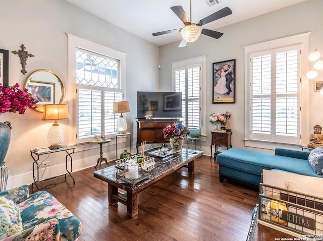 living room featuring ceiling fan and dark hardwood / wood-style flooring