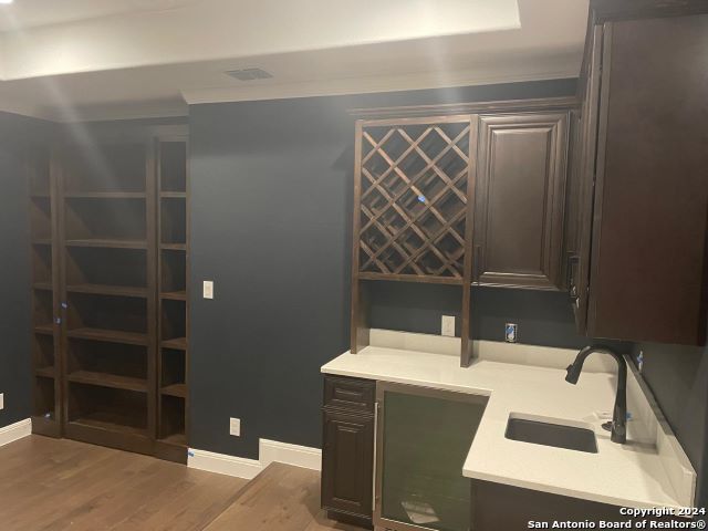 office area with dark wood-type flooring and sink