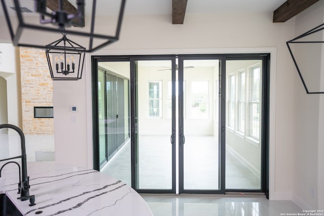 bedroom featuring beamed ceiling, a notable chandelier, and multiple windows