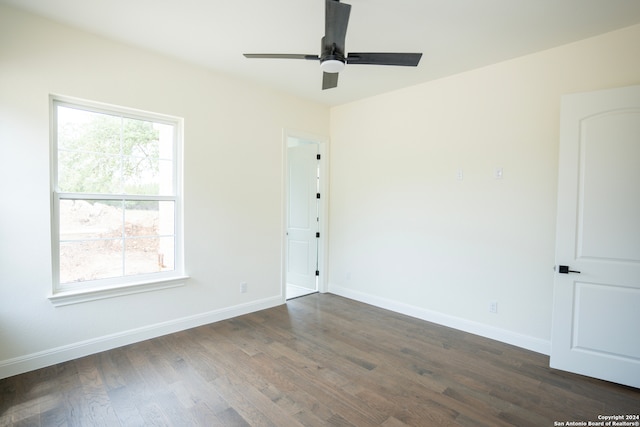 empty room featuring dark hardwood / wood-style floors and ceiling fan