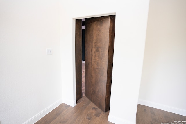 corridor featuring dark hardwood / wood-style floors